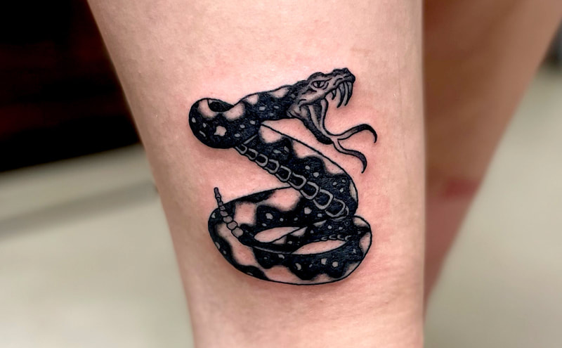 Picture, of a tattoo by Troy, tattoo artist at Top Hat Tattoo, Seattle, black and gray rattle snake