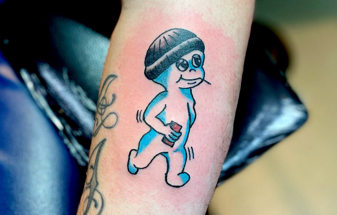 Picture, of a tattoo by Troy, tattoo artist at Top Hat Tattoo, Seattle, casper the friendly ghost wearing a stocking cap and holding a brick