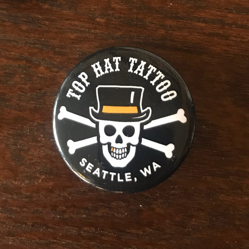 Picture of a Top Hat Tattoo wearable button or pin, merchandise