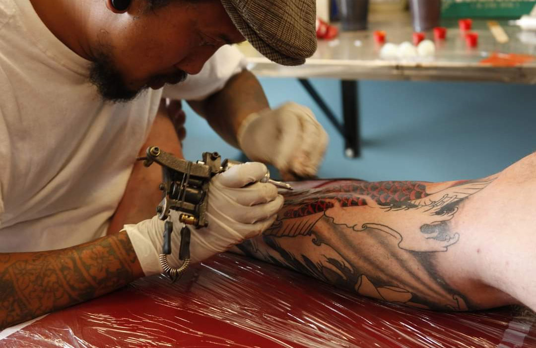 Picture, Agus, the owner of top hat tattoo, mid tattoo