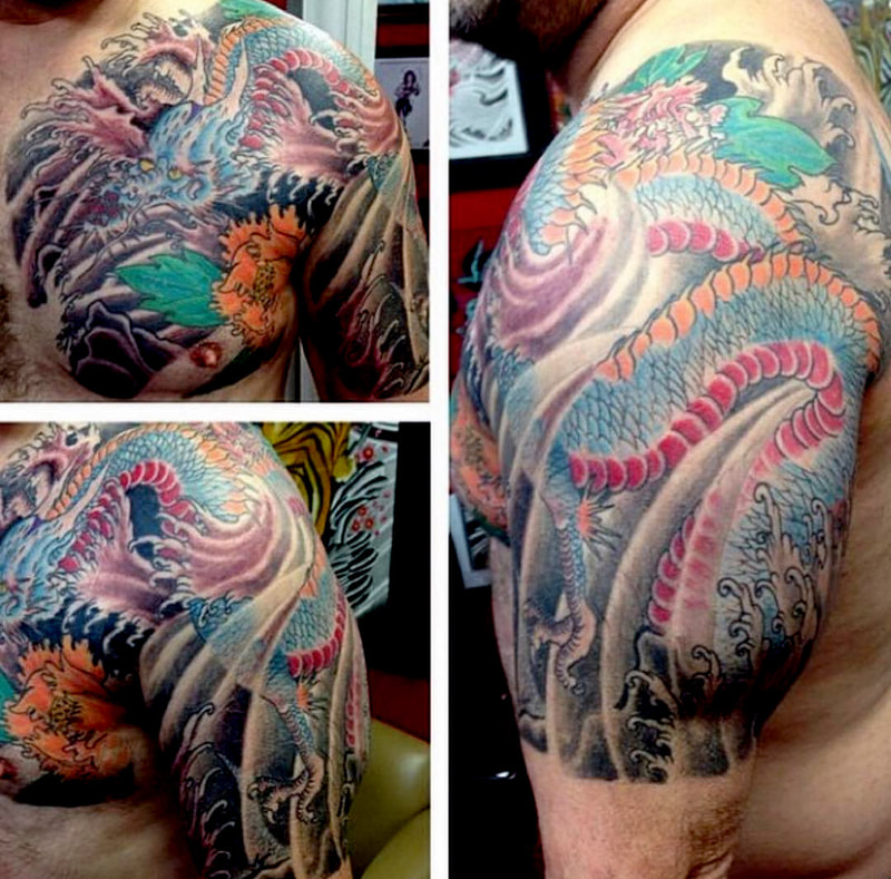 Picture, a tattoo by Agus, owner of Top Hat Tattoo, Seattle, Japanese style dragon that winds up arm, across, shoulder and onto chest