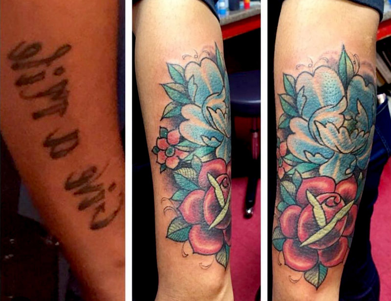 Picture, a tattoo by Agus, owner of Top Hat Tattoo, Seattle, covering up some old illegible text with a rose and a blue flower